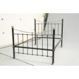 AN EDWARDIAN SILVERED METAL AND CAST IRON BED