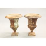 A PAIR OF CAST IRON URNS, of campana form. 44cm high