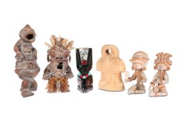 TRIBAL: FOUR EARTHENWARE FIGURES AND A POLISHED GLASS FIGURE