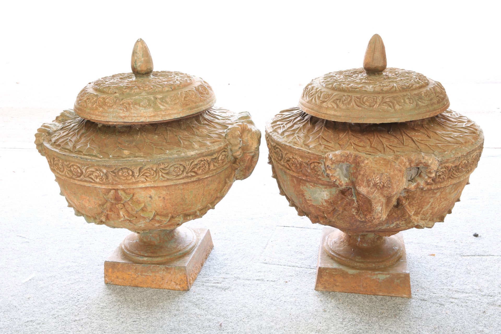 A LARGE AND IMPRESSIVE PAIR OF CAST IRON FLOWER POTS AND COVERS