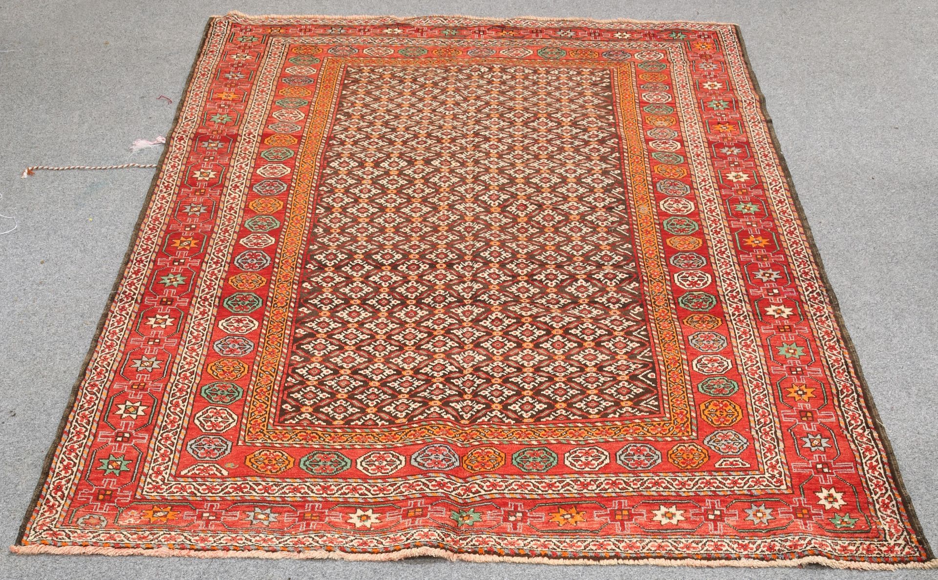 A TRIBAL PERSIAN CARPET. 289cm by 202cm