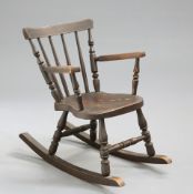 A 19TH CENTURY PAINTED AND SIMULATED ROSEWOOD CHILD'S ROCKING CHAIR