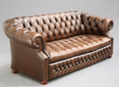 A DEEP-BUTTONED BROWN LEATHER CHESTERFIELD SOFA