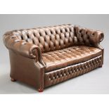 A DEEP-BUTTONED BROWN LEATHER CHESTERFIELD SOFA