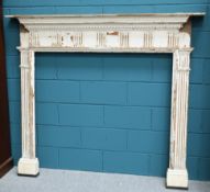 AN 18TH CENTURY PAINTED PINE FIRE SURROUND