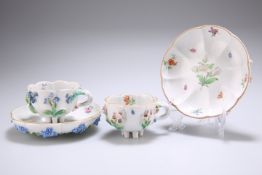 A PAIR OF DRESDEN FLORAL ENCRUSTED CUPS AND SAUCERS