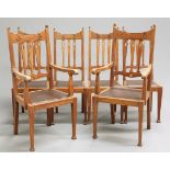 A SET OF SIX ARTS AND CRAFTS OAK DINING CHAIRS