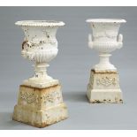 A PAIR OF CAST IRON TWO-HANDLED CAMPANA URNS