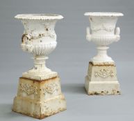 A PAIR OF CAST IRON TWO-HANDLED CAMPANA URNS