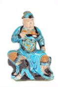 A CHINESE SANCAI GLAZED FIGURE OF A GUARDIAN, LATE MING DYNASTY