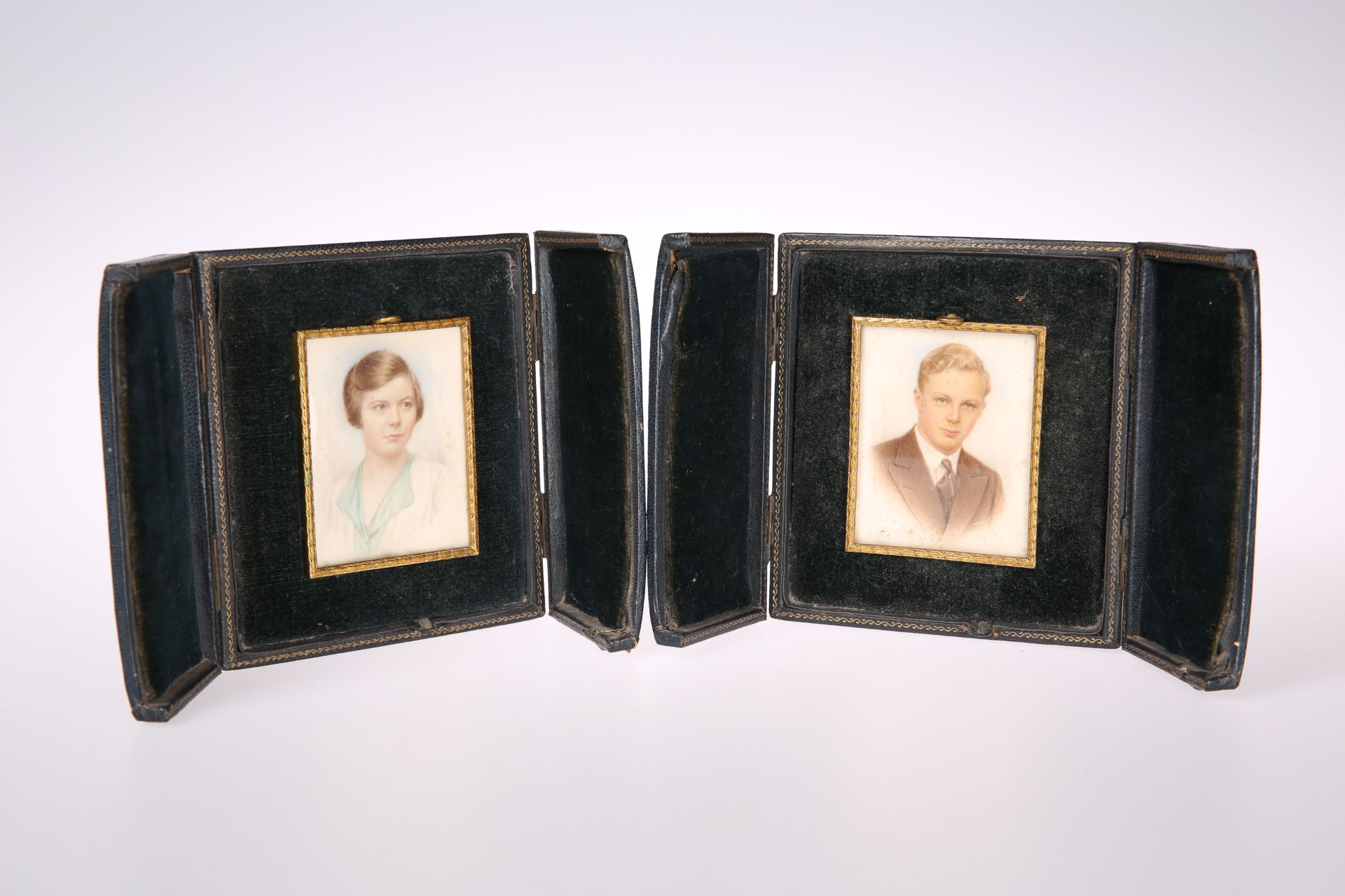 A PAIR OF LEATHER CASED PORTRAIT MINIATURES ON IVORY