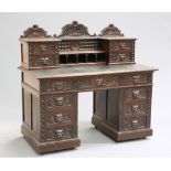 A VICTORIAN CARVED OAK DESK