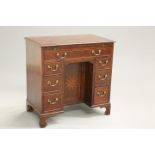 A GEORGE III OAK KNEEHOLE DESK