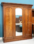 A VICTORIAN MAHOGANY WARDROBE, the moulded cornice above a centre mirror door flanked by a pair of