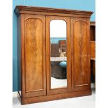 A VICTORIAN MAHOGANY WARDROBE, the moulded cornice above a centre mirror door flanked by a pair of