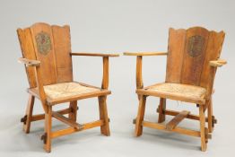 A PAIR OF ARTS AND CRAFTS OAK OPEN ARMCHAIRS,