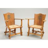 A PAIR OF ARTS AND CRAFTS OAK OPEN ARMCHAIRS,