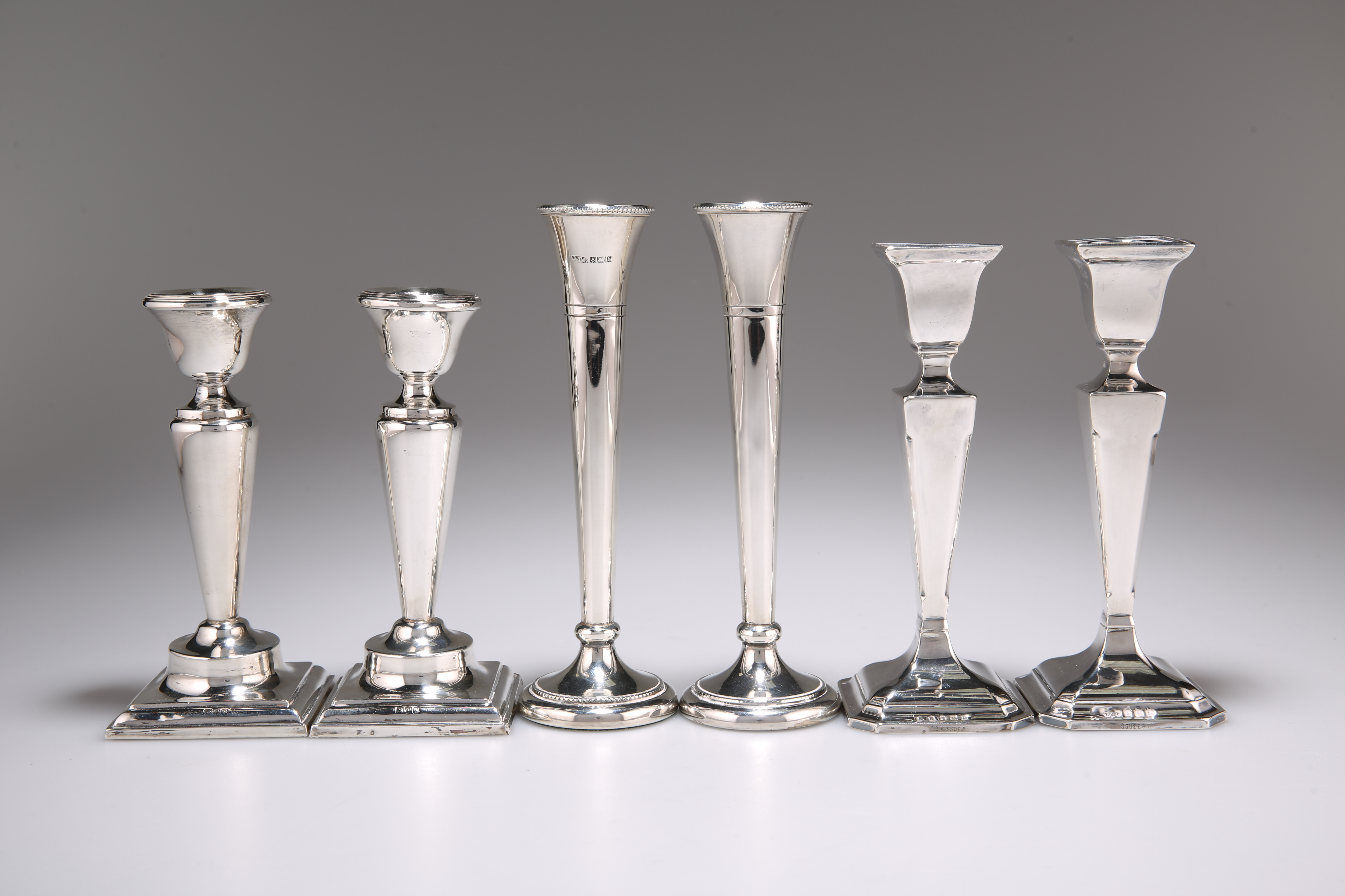 A PAIR OF GEORGE V SILVER CANDLESTICKS