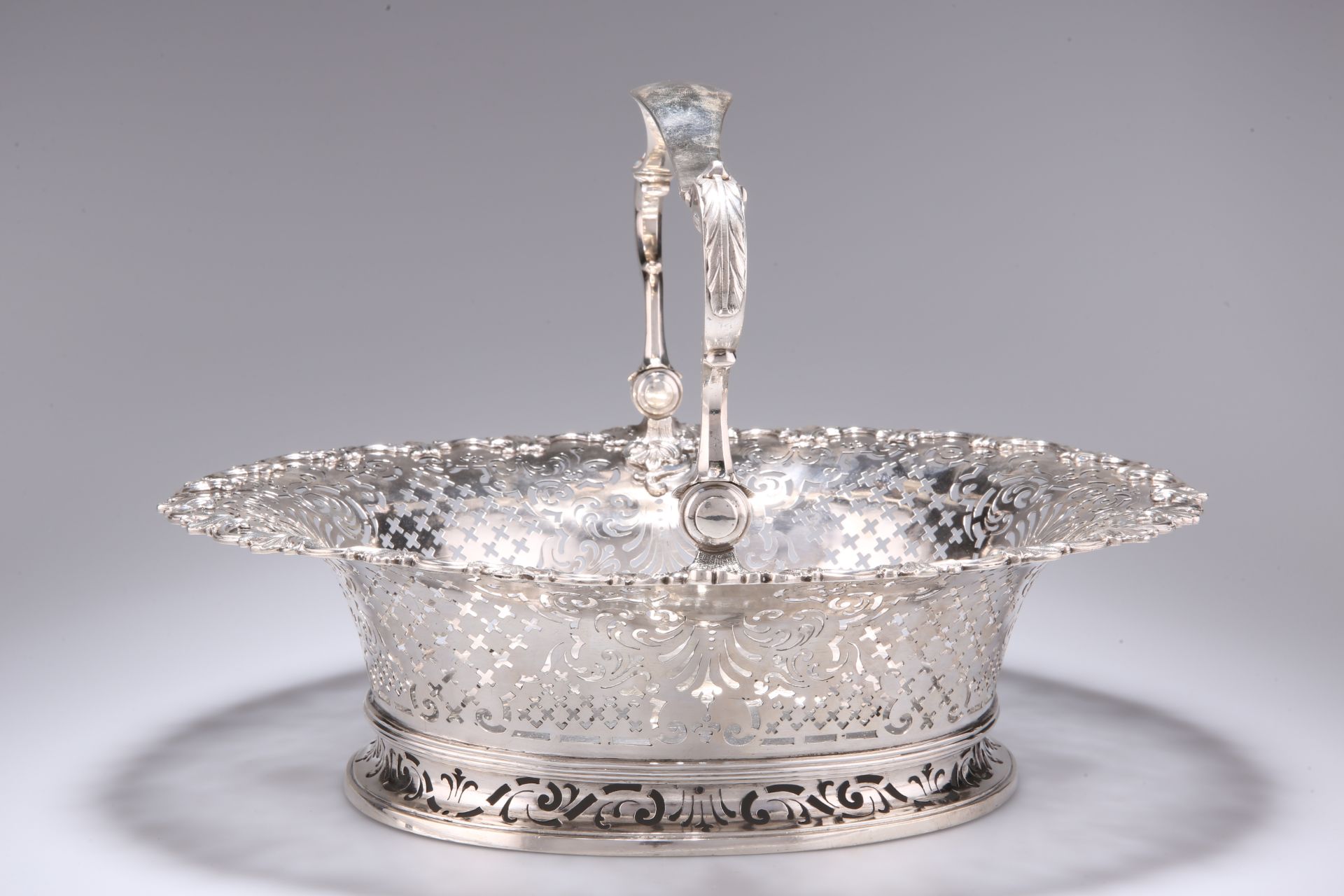 A FINE GEORGE II ROCOCO CAST SILVER SWING-HANDLED CAKE BASKET - Image 3 of 5