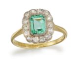 AN 18CT AND PLATINUM EMERALD AND DIAMOND CLUSTER RING