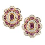 A PAIR OF RUBY AND DIAMOND EARRINGS, the central oval faceted ruby, collet mounted and surrounded by