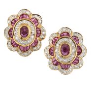 A PAIR OF RUBY AND DIAMOND EARRINGS, the central oval faceted ruby, collet mounted and surrounded by