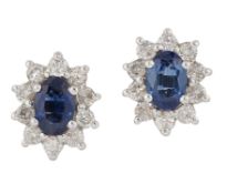 A PAIR OF SAPPHIRE AND DIAMOND CLUSTER EARRINGS