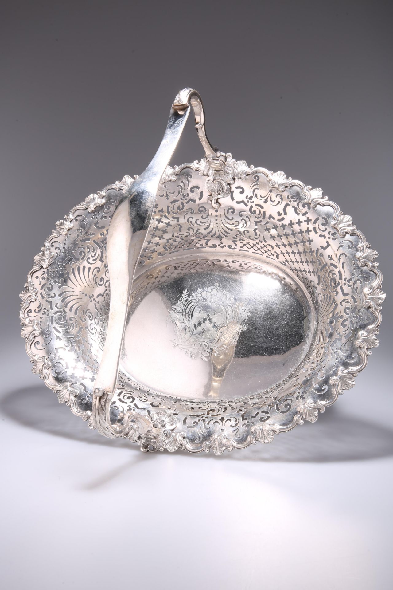 A FINE GEORGE II ROCOCO CAST SILVER SWING-HANDLED CAKE BASKET