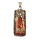 A COMPOSITE AMBER AND SILVER PENDANT