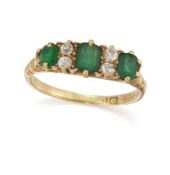 WITHDRAWN AN 18CT THREE STONE EMERALD AND DIAMOND RING, the central cushion cut emerald, set to