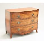 AN EARLY 19TH CENTURY MAHOGANY BOW-FRONT CHEST OF DRAWERS