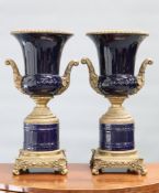 A LARGE PAIR OF GILT-METAL MOUNTED BLUE-GLAZED URNS