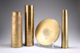 THREE BRASS SHELL CASES AND A SHELL CASE HEAD