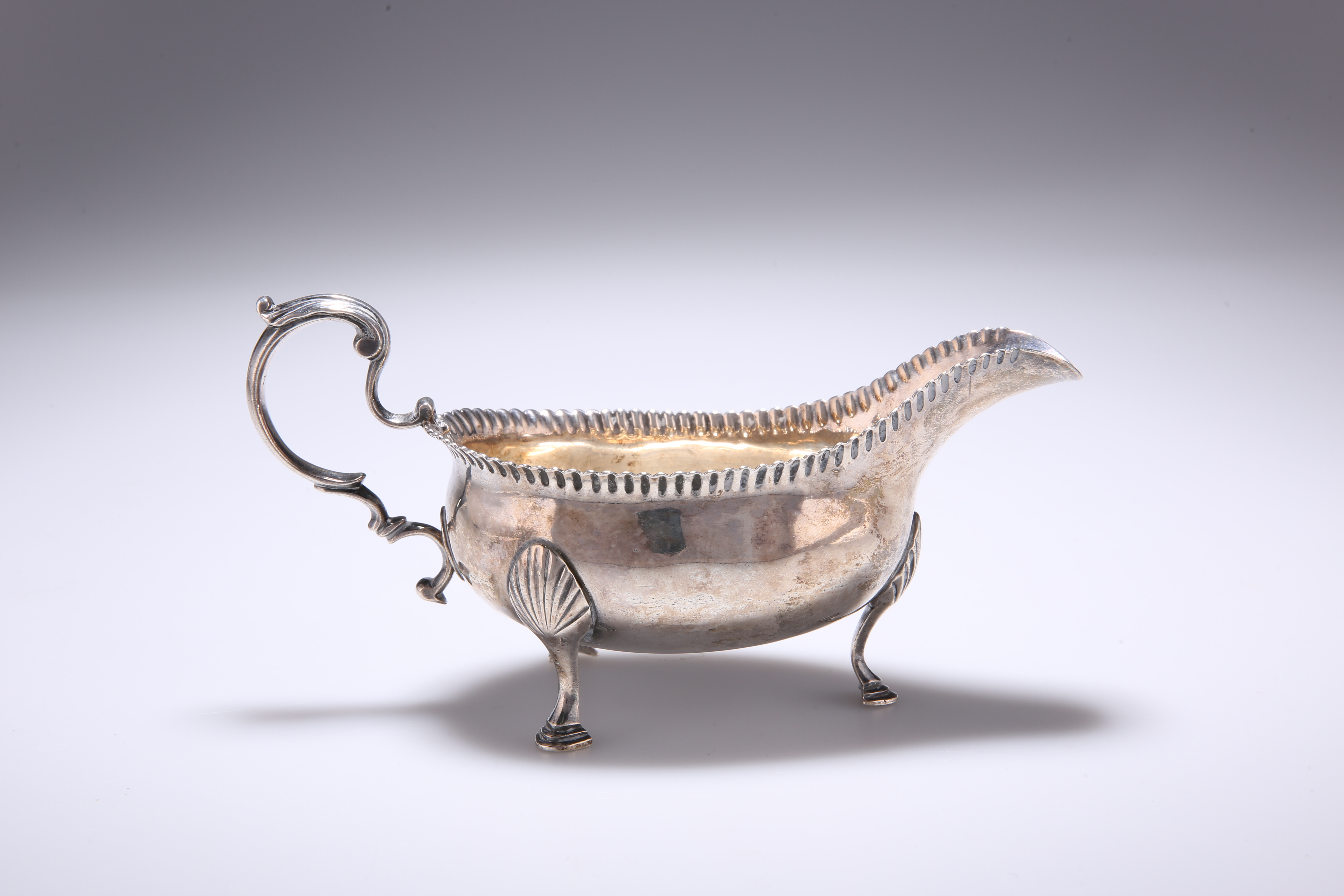 A GEORGE III PROVINCIAL SILVER SAUCE BOAT