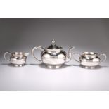 A CHINESE SILVER THREE PIECE TEA SERVICE, by Wang Hing & Co, late 19th/early 20th century, the squat