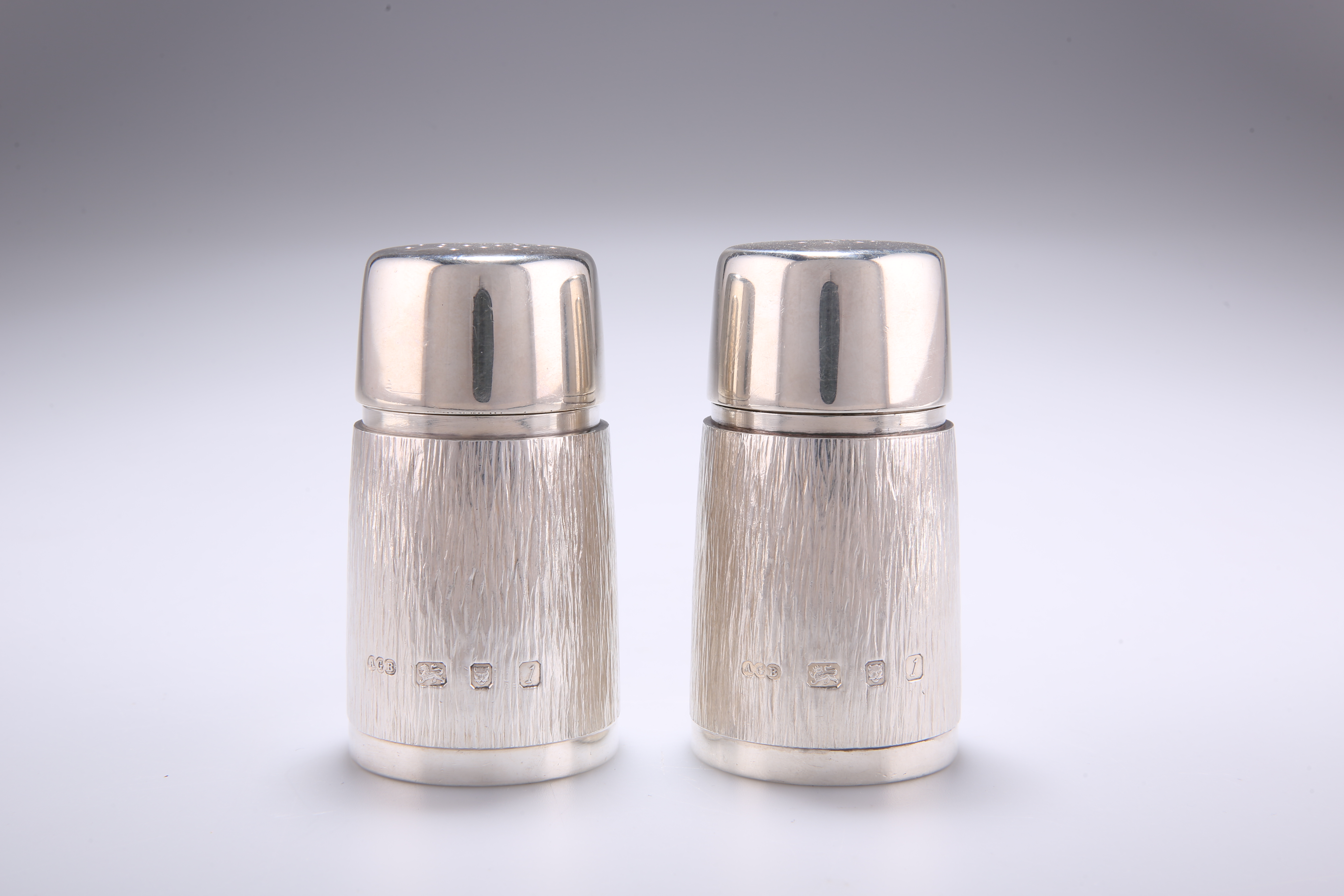 A PAIR OF ELIZABETH II SILVER PEPPER POTS, by Gerald Benney, London 1966