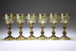 SIX 19TH CENTURY BOHEMIAN GREEN GLASS WINES, the bowls enamel painted with fruiting vine and