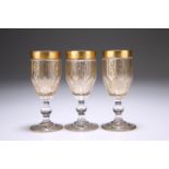 A SET OF THREE CONTINENTAL 19TH CENTURY GILDED LIQUEUR GLASSES, the deep bowls with interlocking cut