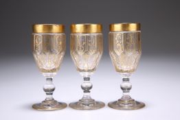 A SET OF THREE CONTINENTAL 19TH CENTURY GILDED LIQUEUR GLASSES, the deep bowls with interlocking cut