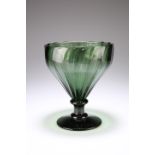 A VERY LARGE RIBBED GREEN GLASS RUMMER, 19TH CENTURY, the slightly wrythen bowl raised on a short