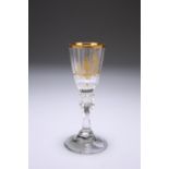 A CONTINENTAL GILDED DRINKING GLASS, CIRCA 1775, the faceted bowl gilded with the figure of a