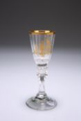 A CONTINENTAL GILDED DRINKING GLASS, CIRCA 1775, the faceted bowl gilded with the figure of a