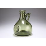 A GREEN GLASS SEAL FLAGON, mallet-shaped with short neck. 17cm high Provenance: The Chris Crabtree