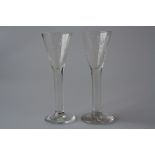 A PAIR OF LATE 18TH CENTURY WINE OR SCHNAPPS GLASSES, each funnel bowl engraved with monogram and