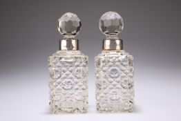 A PAIR OF EDWARDIAN GLASS SCENT BOTTLES WITH SILVER COLLARS by Miller Brothers, London 1903, of