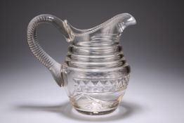 A LARGE 19TH CENTURY CUT-GLASS WATER JUG, cut with swags and with substantial looping handle. 20.5cm