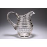 A LARGE 19TH CENTURY CUT-GLASS WATER JUG, cut with swags and with substantial looping handle. 20.5cm