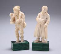 A PAIR OF 19TH CENTURY IVORY FIGURES, PROBABLY RUSSIAN, carved as peasants, on malachite bases. 11.