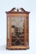 A 19TH CENTURY INLAID MAHOGANY GLAZED HANGING CORNER CABINET, with swan neck pediment centred by a