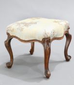 A VICTORIAN WALNUT STOOL, the upholstered seat raised on cabriole lets. 41cm wide